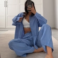 Women's blue striped pajama set featuring long-sleeved shirt and wide-leg lounge pants - S / Blue