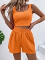 Close-up of bright orange rib-knit cotton loungewear set with crop top and shorts - Orange Red
