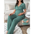 Detail view of the adjustable elastic waistband on ribbed maternity lounge set pants - Green