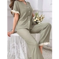 Close-up of ruffled hem details on sage green pajama set with waffle texture fabric - S / Top And Bottom / Light Green