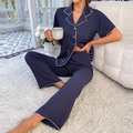 Detailed view of dark blue textured pajamas with white piping and button closure - S / Top And Bottom / Sapphire Blue