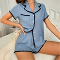 Detail of light blue pajama set showing textured fabric and black heart wavy lace edging - Blue