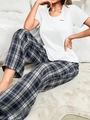Detail of soft plaid lounge pants paired with a white short sleeve tee featuring a patch - S / Off White