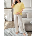 Detail of the yellow button-up short sleeve top with pleated texture and white wide-leg pants - Yellow
