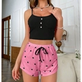 Women's 2-piece pajama set featuring a black ribbed camisole and pink heart print shorts - Black
