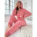 Detail of pink coral fleece jumpsuit showing textured checkerboard pattern and hooded pompom - Pink