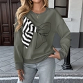 Detail of army green sweatshirt featuring a 3D black and white striped bow decoration - Dark Gray