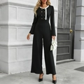 Eleganter langärmeliger Jumpsuit in Schwarz mit weißem Kontrast und goldfarbenen Knöpfen - S / Schwarz