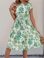 Detailed view of the green floral print on a short-sleeved tie-waist pleated summer dress - S / Green