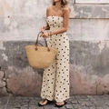 Detail of polka dot strapless jumpsuit fabric with matching straw tote bag on a rustic street - S / Apricot