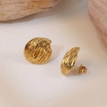 Golden organic shaped stud earrings with vertical striped texture on a natural stone surface - Fyd6144