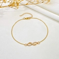Detailed view of a gold infinity anklet with crystals on an elegant silk background - Rhinestone Infinity Symbol Anklet (KC Gold, K-884)