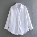 Detailed view of white poplin shirt featuring classic collar and button-down cuffs - XS / White