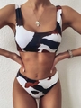 Detail of a cow print bikini set featuring wide straps and a sporty scoop neck top - S / Brown