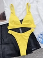 Detailed view of yellow ribbed bikini texture with adjustable straps and metal ring details - S / Yellow