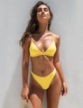 Detail of bright yellow bikini set showing elastic fabric and side triangle cup design - Yellow