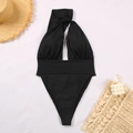 Detailed flat lay of black one-piece swimsuit with cutout detail and beach accessories - S / Black