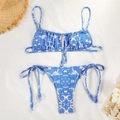 Flat lay of blue paisley bikini set with tie-side bottoms and decorative beach accessories - S / Blue Paisley Print