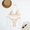 Flat lay of champagne nylon bikini with halter top and gold metal strap accents - S / Champagne