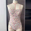 Detail of floral one-piece swimsuit featuring thin straps and pleated chest design - S / Yellow Floral