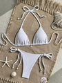 Flat lay of white textured bikini set with a pink shell charm and beach decorations - S / White