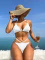 Detailed view of white textured bikini set with metal buckle and cross-strap waist design - S / White