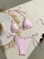 Close-up of pink bikini with ribbed texture, sea shells and starfish charms on flat lay - S / Pink