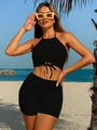 Detail of black ribbed halter bikini set with lace-up cutout on beach background - S / Black