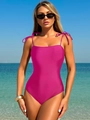 Detail of hot pink one-piece swimsuit featuring adjustable shoulder bow ties on the straps - Pink