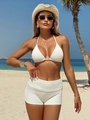 Three-piece solid white textured bikini set with high-waist shorts on a tropical beach - S / Off-white