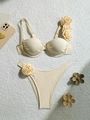 Detailed flat lay of beige push-up bikini set with elegant 3D fabric rose flower accents - S / Beige
