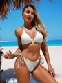 Detalle de la textura del bikini blanco halter con lazo dorado y perla en la playa - S / Blanco