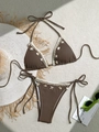 Flat lay of brown textured bikini with white lace trim and seashell charms on a neutral rug - S / Top And Bottom / Brown