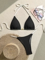 Detail of black ribbed bikini set featuring white ties and golden shell charm ornament - S / Black