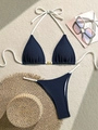 Detail of dark blue waffle texture bikini with gold shell buckle and white side ties - S / Blue