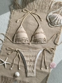 Detailed macro of beige ruffle bikini top featuring natural shell charms on the ties - S / Top And Bottom / Brown