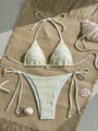 Three-piece solid color bikini with ruffle edges and seashell charms on jute background - S / Beige