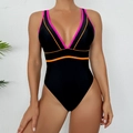 Detail of black one-piece swimsuit with vibrant neon pink and orange trim accents - S / Black