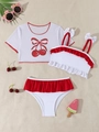 Flat lay of girls' white three-piece bikini set with red cherry print and ruffles - White
