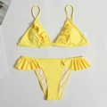 Detail of size M label on bright yellow ruffle bikini top with pleated texture - Yellow
