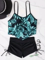 Flat lay of tropical palm leaf ruffled bikini top and high waisted drawstring swim shorts - S / Green