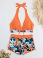 Flat lay of high waisted two-piece bikini with orange halter top and floral boyshorts - S / Orange