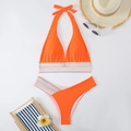 Flat lay of bright orange bikini with woven colorful decorative bands and beach accessories - S / Orange