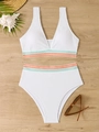 Flat lay of high waisted white bikini with colorful wavy trim on textured fabric - S / White
