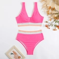 Detail of pink smocked bikini with colorful wavy trim and textured fabric on white background - S / Pink