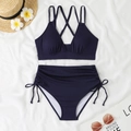 Flat lay of navy ribbed bikini with high waisted drawstring bottoms and summer accessories - S / Navy Blue