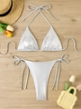 Flat lay of metallic silver bikini set with halter top and string bottoms on wood background - S / Silver