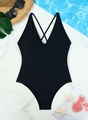 Flat lay of black one-piece swimsuit with cross-back straps on blue water background - S / Black