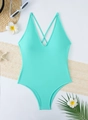 Flat lay of mint green one-piece swimsuit with V-neckline and tropical summer accessories - S / Lake Blue