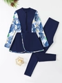 Detail of long-sleeve two-piece rash guard set with tropical leaf prints and leggings - Blue